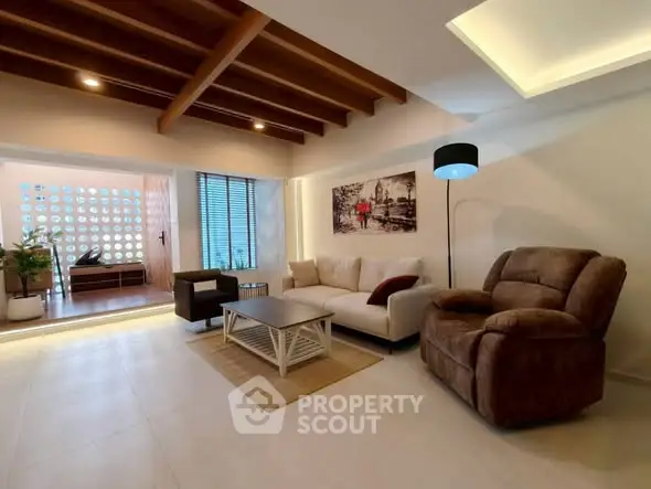 Spacious living room with modern decor and cozy seating area