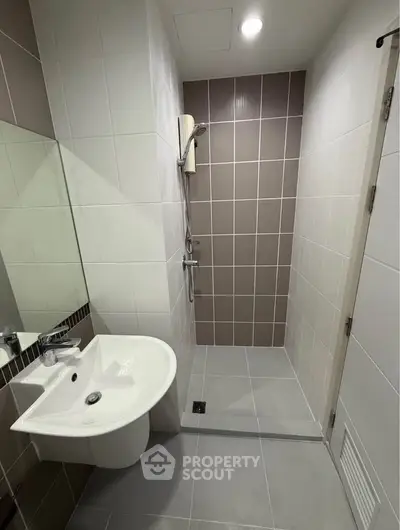 Modern bathroom with sleek shower and stylish sink in contemporary design.