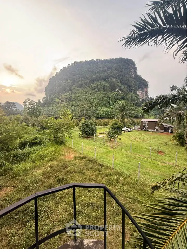 Scenic view of lush greenery and mountain from a balcony, perfect for nature lovers seeking tranquility.