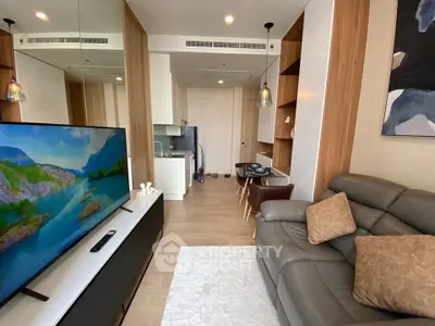 Modern living room with sleek furniture and open kitchen layout