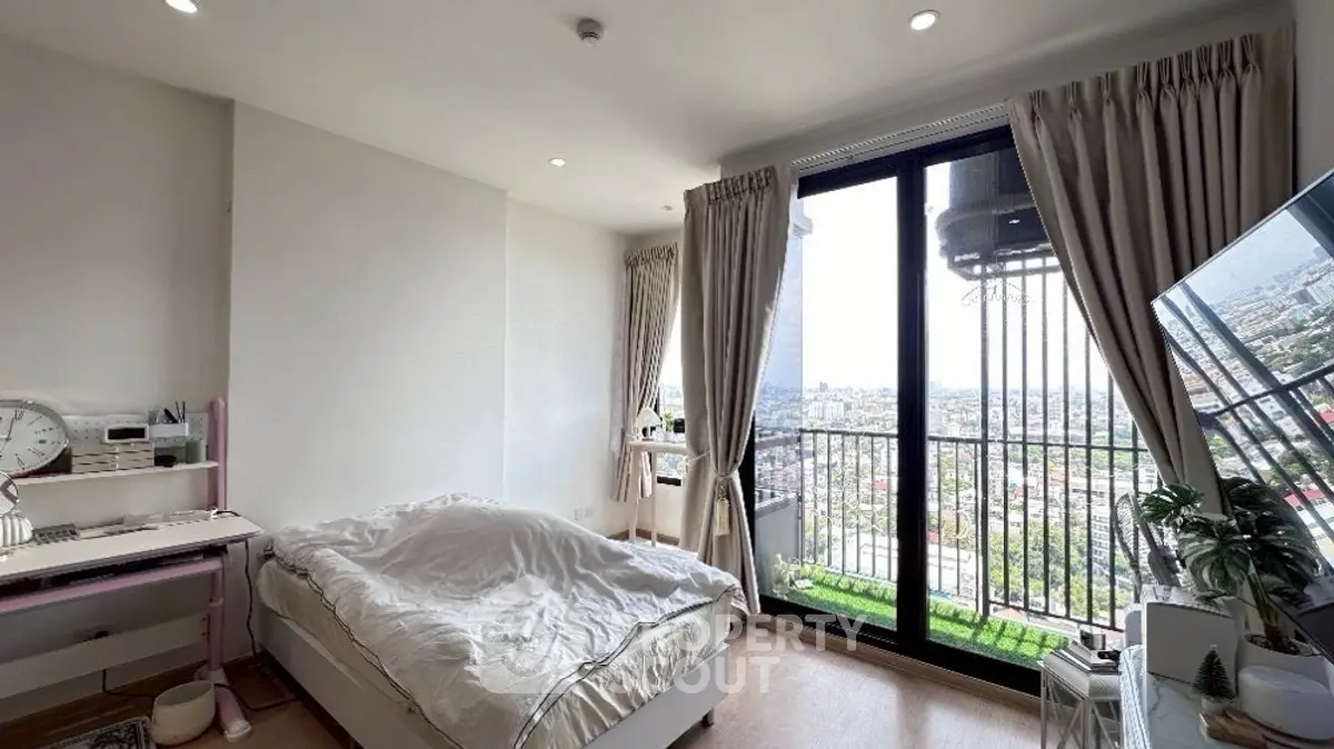 Bright bedroom with city view and balcony access in modern apartment
