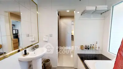 Modern bathroom with sleek fixtures and a bathtub, featuring a bright and clean design.