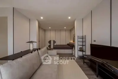 Modern living room with sleek design and neutral tones, featuring a comfortable sofa and stylish decor.