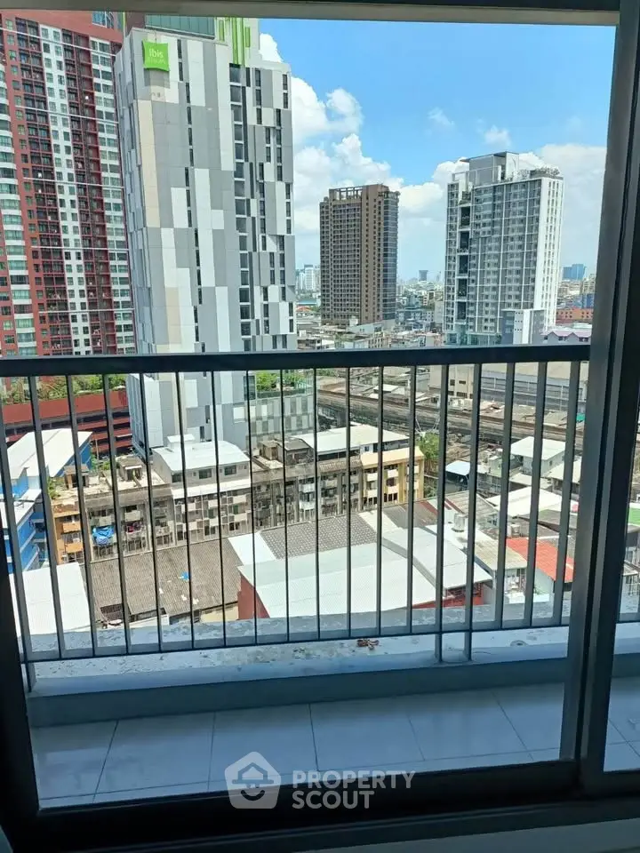 Stunning urban view from a high-rise balcony overlooking city skyline and modern architecture.