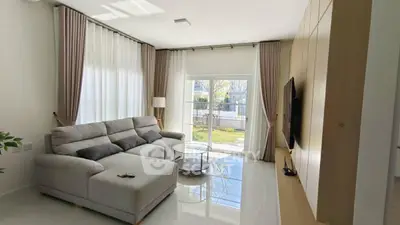 Spacious modern living room with large windows and cozy sectional sofa