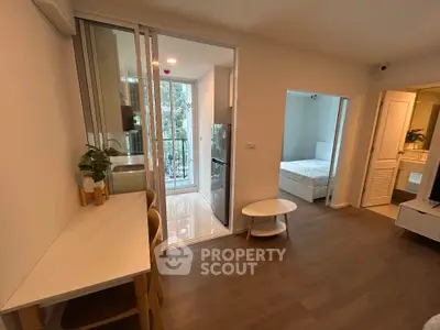 Modern apartment interior with open layout, featuring a cozy bedroom and stylish kitchen area.