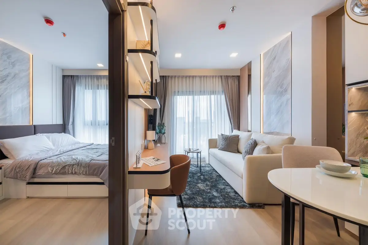 Modern open-plan living room and bedroom with stylish decor and natural light