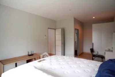 Spacious bedroom with modern furniture and neutral decor