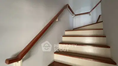 Elegant staircase with wooden handrails in modern home interior