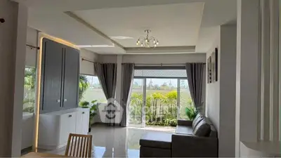 Spacious living room with modern decor and garden view