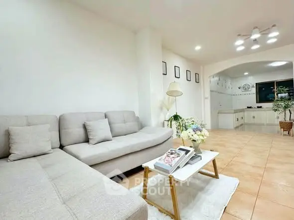 Spacious living room with modern decor and open kitchen layout