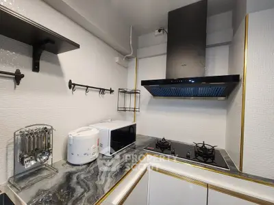 Modern kitchen with sleek gas stove and microwave in stylish apartment