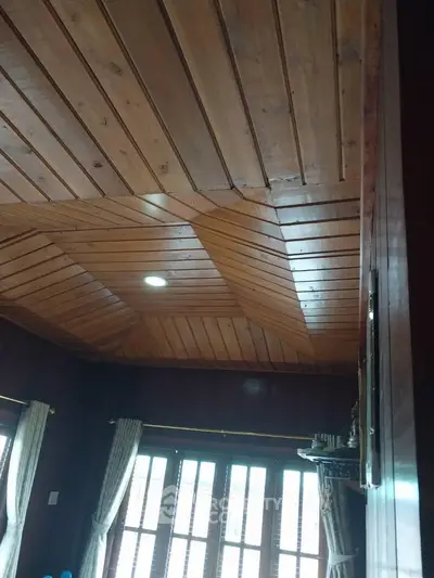 Charming wooden ceiling with natural light in cozy living room