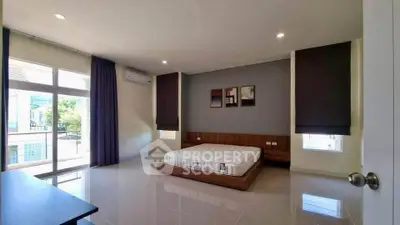 Spacious modern bedroom with large windows and minimalist decor.