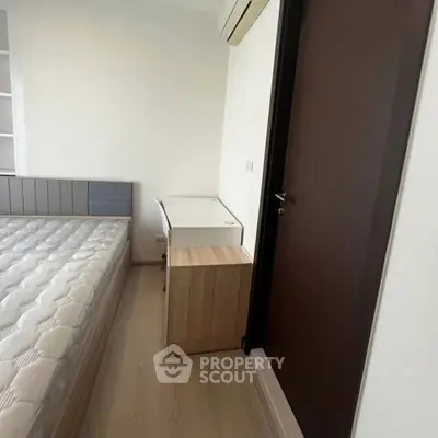 Modern bedroom with minimalist design and wooden flooring