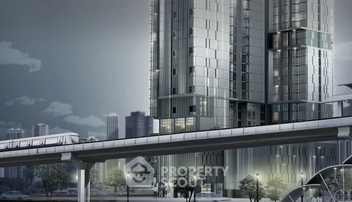 Modern high-rise building with sleek design near urban transit line.