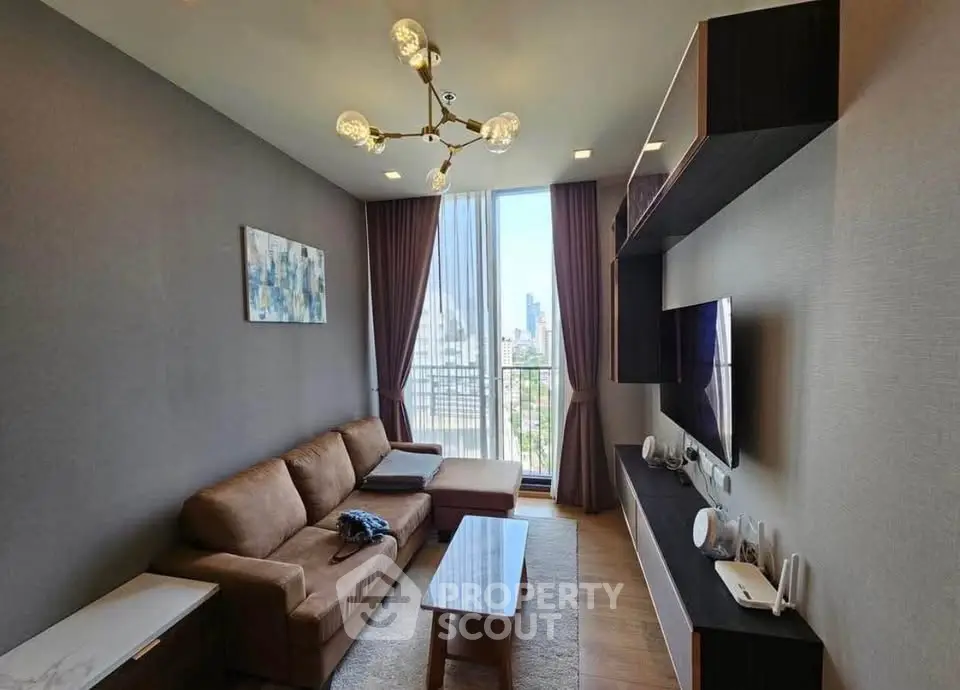 Modern living room with city view, stylish furniture, and elegant lighting in a high-rise apartment.