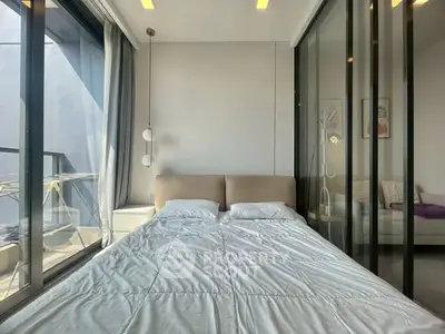 Modern bedroom with floor-to-ceiling windows and stylish decor