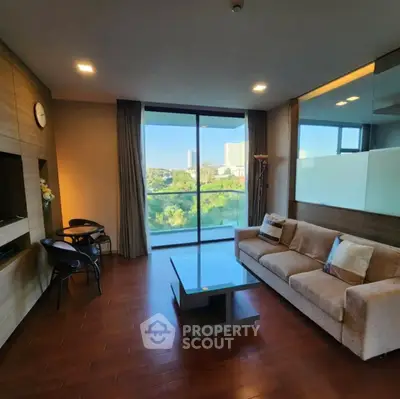 Spacious living room with modern decor and large window offering a scenic view.