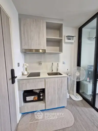 Modern compact kitchen with sleek cabinetry and appliances