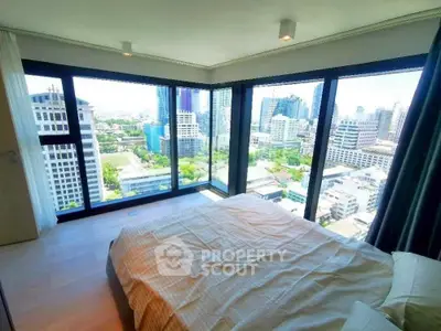 Luxurious corner bedroom with panoramic city views in a high-rise apartment.