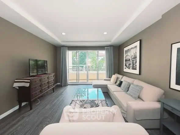 Spacious living room with elegant decor and large windows offering natural light.