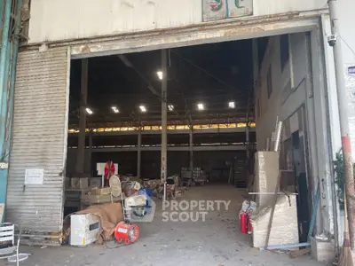 Spacious industrial warehouse with open entrance and ample storage space