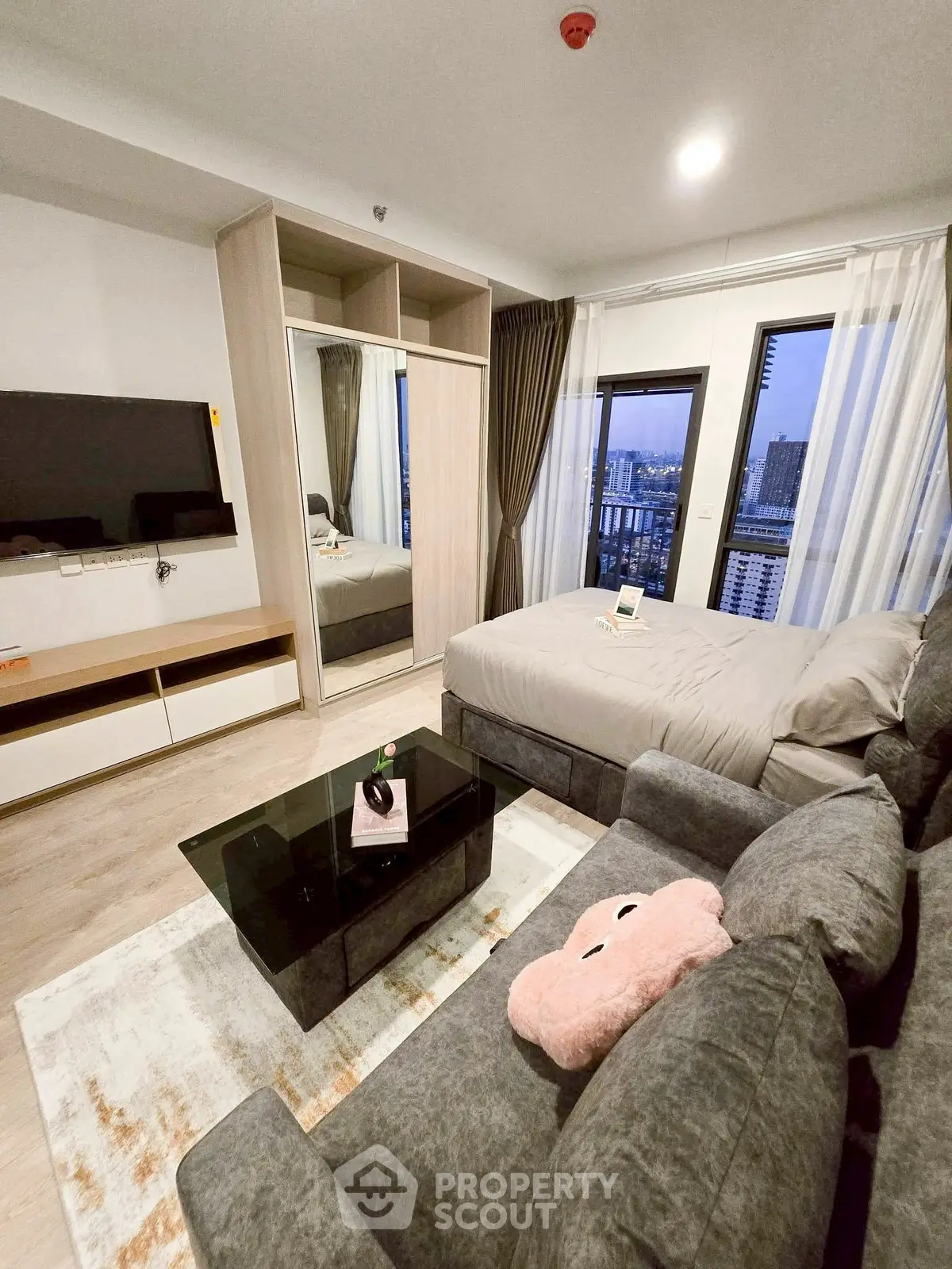 Modern studio apartment with cozy living area and city view