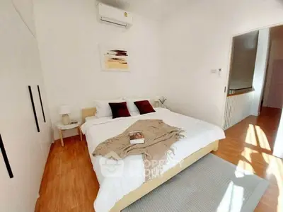 Bright and cozy bedroom with modern decor and wooden flooring