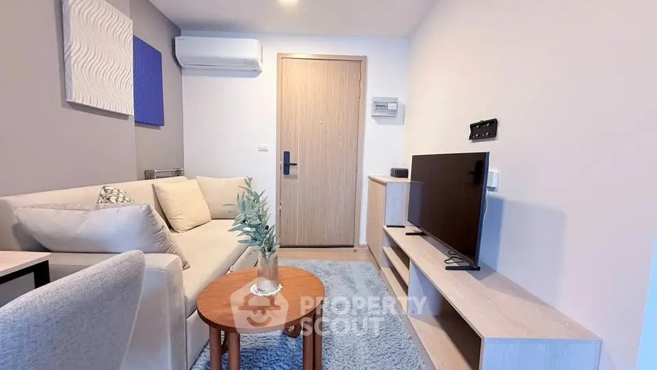 Modern living room with cozy sofa, TV, and stylish decor in a contemporary apartment.