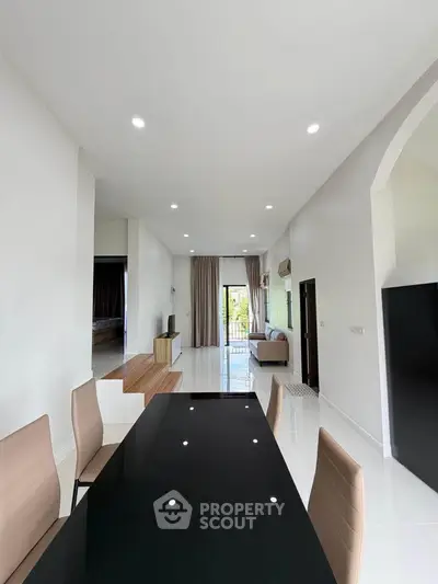 Spacious modern living room with sleek dining area and natural light
