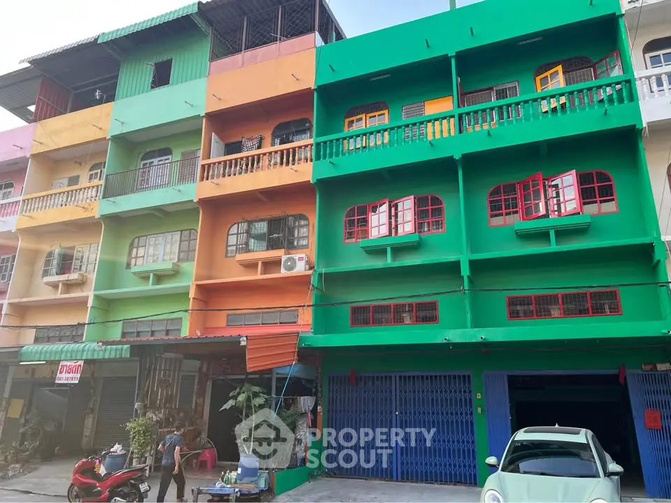 Vibrant multi-colored building exterior with balconies and street view