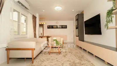 Spacious modern living room with elegant decor and large TV