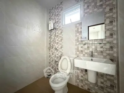 Modern bathroom with stylish tile design and compact fixtures