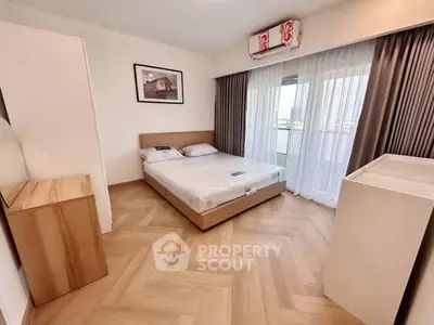 Modern bedroom with stylish parquet flooring and large window with city view.