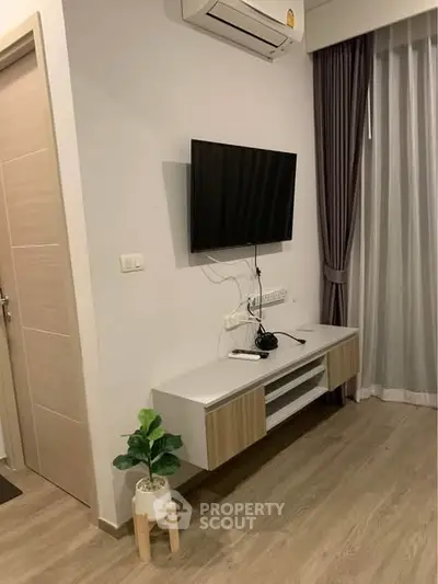 Modern living room with wall-mounted TV and sleek air conditioning unit.