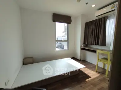 Cozy bedroom with natural light, featuring a minimalist design and wooden flooring, perfect for modern living.