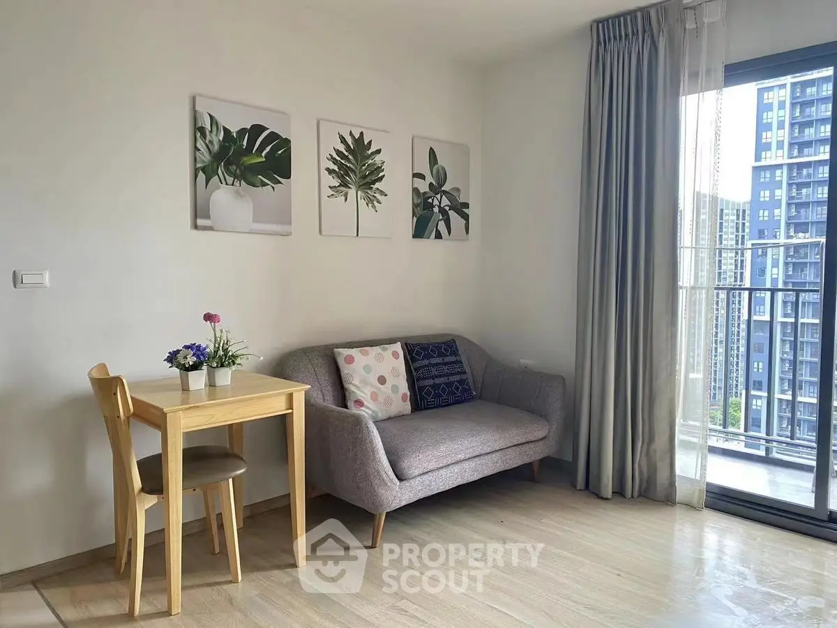 Charming living room with cozy sofa and balcony view in modern apartment.