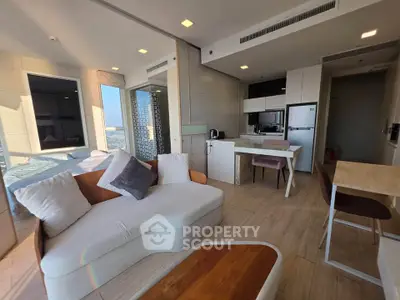 Modern living room with open kitchen and stylish furniture in a high-rise apartment