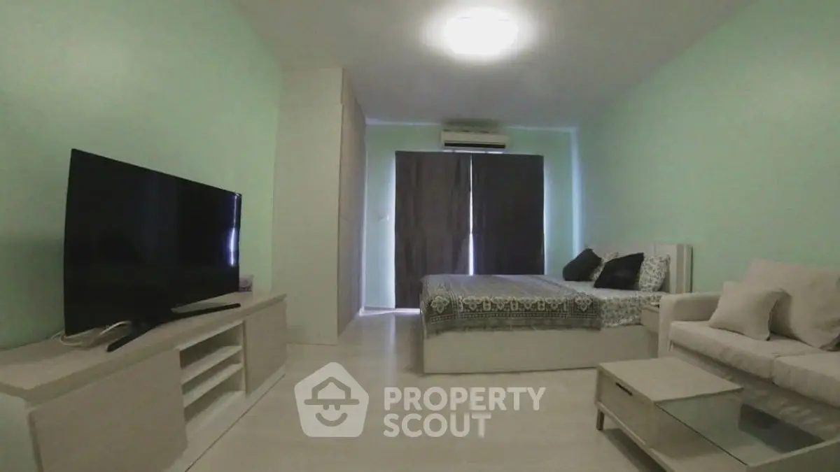 Modern studio apartment with cozy living area and stylish decor