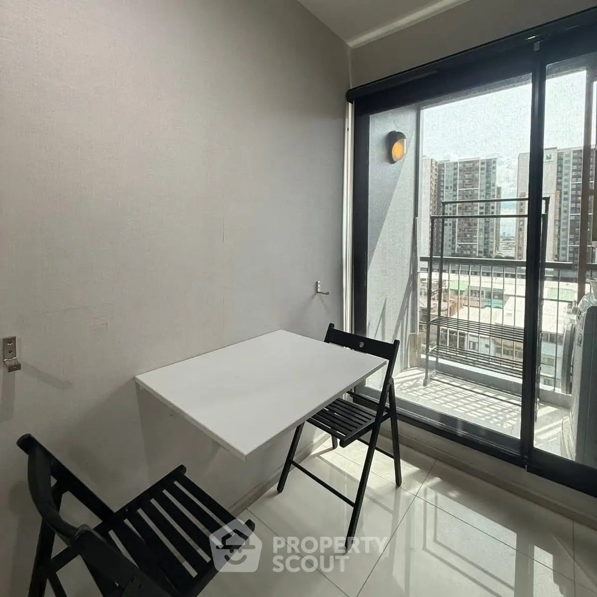 Modern apartment dining area with balcony view and sleek furniture