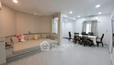 Spacious living room with dining area and cozy seating, perfect for family gatherings.