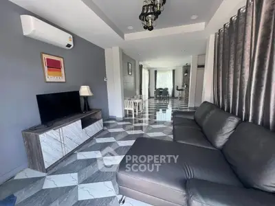 Modern living room with stylish furniture and geometric flooring