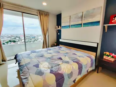 Spacious bedroom with large window and city view, modern decor and cozy ambiance.