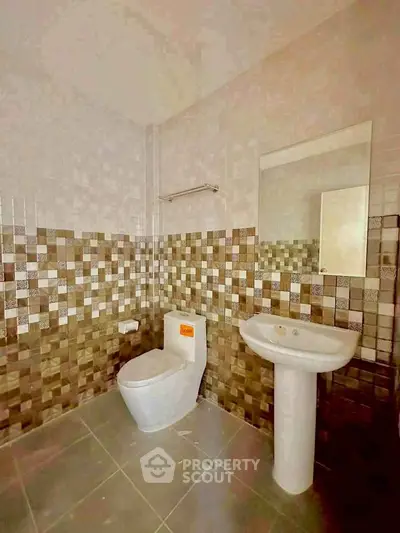 Modern bathroom with stylish tile design and pedestal sink