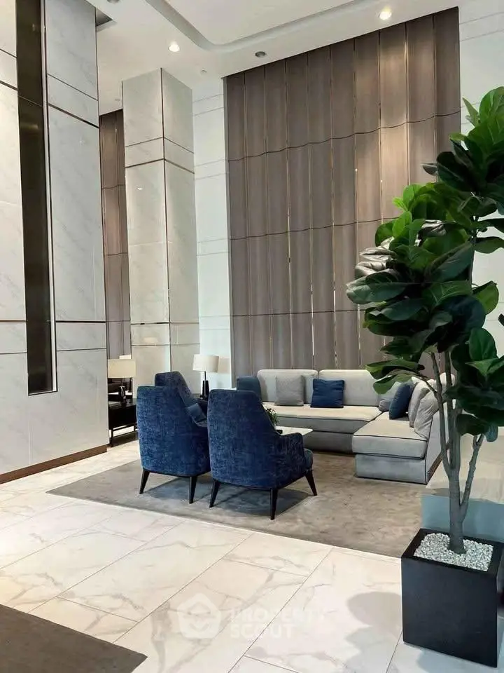 Luxurious modern lobby with elegant seating and marble flooring in a high-end residential building.