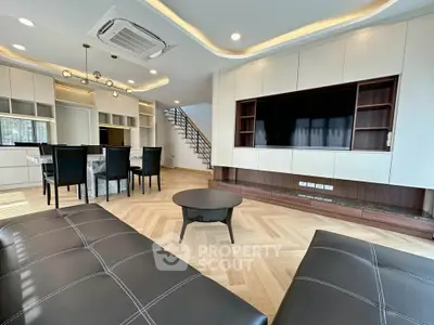 Luxurious modern living room with sleek furniture and elegant lighting in a spacious open layout.