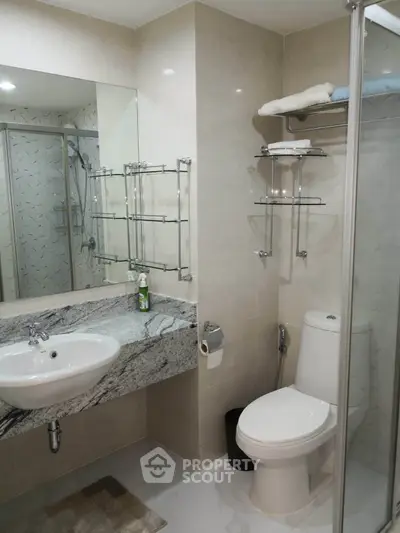 Modern bathroom with sleek fixtures and glass shower enclosure