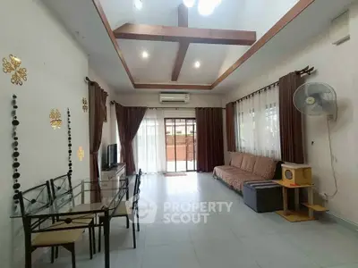 Spacious living room with modern decor and large windows for natural light.