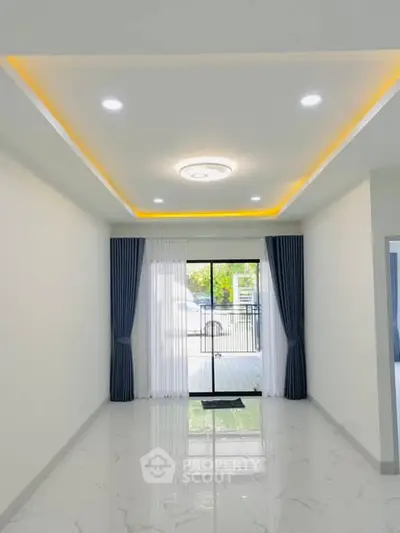 Spacious modern living room with elegant lighting and large windows for natural light.